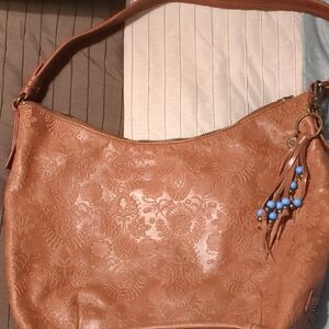 The Sak Tan and Blue Hobo Bag with Embossed Design
